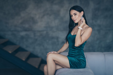 Profile photo of tenderness lady sitting on comfy modern sofa remembering last ideal love night touch earring ear wear formalwear shiny short mini dress apartments indoors