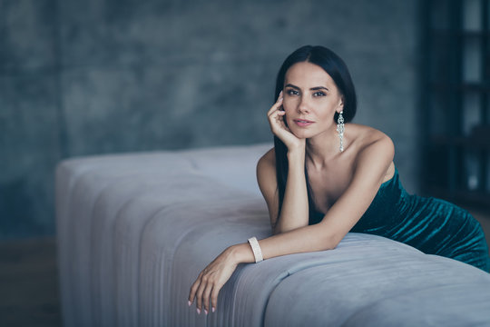 Photo of tenderness classy lady leaning on comfortable sofa waiting boyfriend home wear teasing classy formalwear short shiny dress apartments indoors