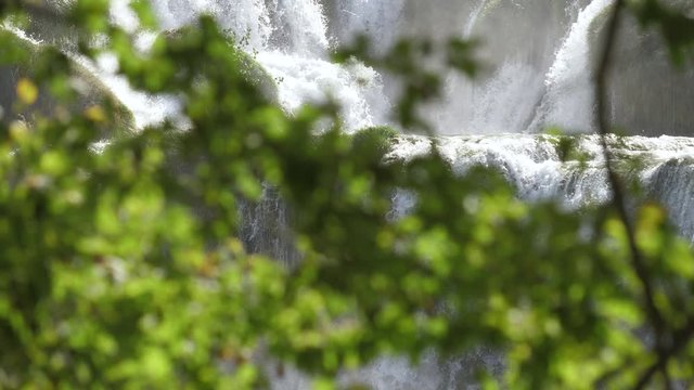 a view through the trees on the famous waterfalls of Krka
