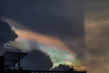 Beautiful iridescent cloud, Irisation. Skyscraper background