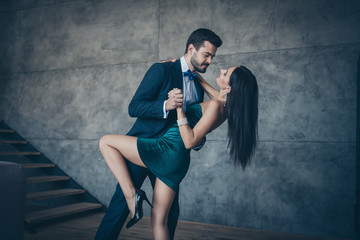 Profile photo of two stylish trendy people couple guy and lady slow dancing bending back holding...