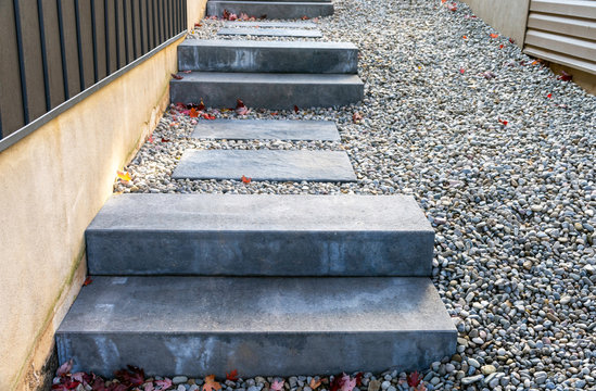 Precast concrete steps provide a safe and comfortable landscaping solution to address the steep grade between two houses.