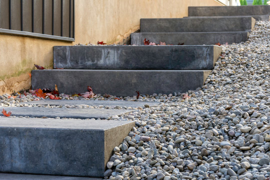 Precast concrete steps provide a safe and comfortable landscaping solution to address the steep grade between two houses.