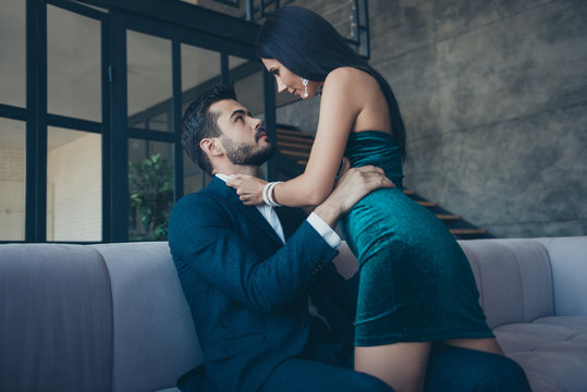 Profile photo of tenderness style couple guy lady sitting big sofa tempting prelude undress intimate erotic desire wear fancy formalwear blue suit short shiny dress loft industrial indoors