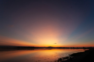 Fototapeta premium Beautiful sunset reflected in the lake.Fiery orange sunset sky. Beautiful sky
