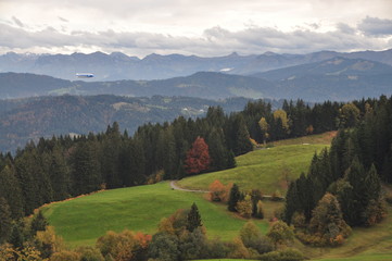 a zeppelin airship flying over the Alps on an autumn day seen from the Pfänder, Voralberg, Austria © Simo