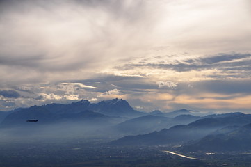 a zeppelin airship flying over the Alps seen from the Pfänder, Voralberg, Austria © Simo