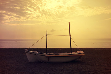 Naklejka premium Sunrise in popular volcanic beach of Perissa with dark sandy seascape, Santorini island, Cyclades, Greece