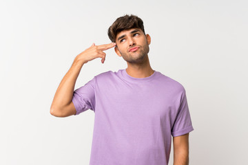 Young handsome man over isolated white background with problems making suicide gesture