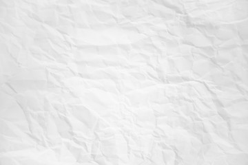 white and gray wide crumpled paper texture background. crush paper so that it becomes creased and...