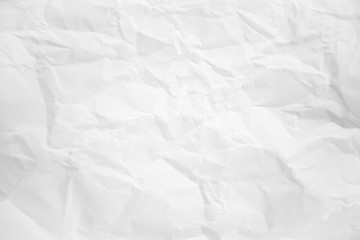 white and gray wide crumpled paper texture background. crush paper so that it becomes creased and...