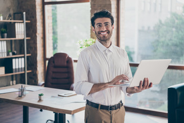 Portrait of positive confident smart middle eastern entrepreneur man hold laptop using feel success...