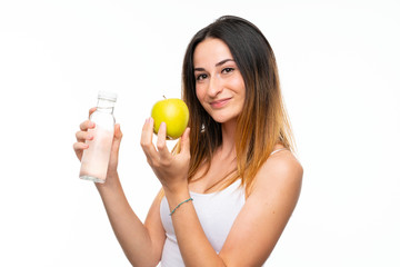 Young woman with an apple over isolated white background