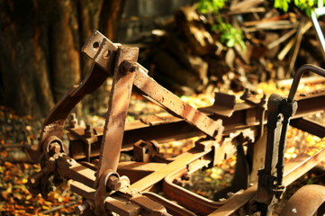Rusty plow with big knife left on the farm