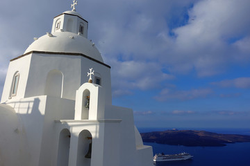 Photo from picturesque orthodox chapel in beautiful village of Fira overlooking the caldera, Santorini island, Cyclades, Greece