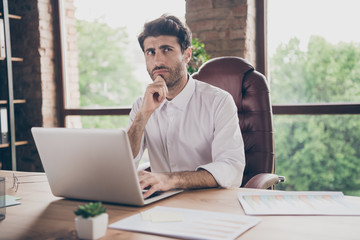 What answer.... Portrait of doubtful thoughtful middle eastern business man using his laptop...