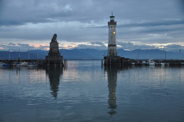 Fototapeta premium the Bavarian lion and the ligthouse at the entrance of Lindau harbor, Lake Constance, Bavaria, Germany