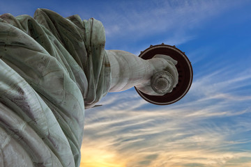Extreme close up of hand and torch of Statue of Liberty at sunrise, looking from ground. © Wollwerth Imagery