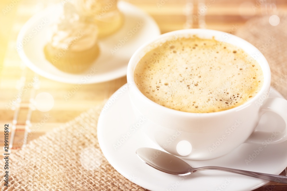 Sticker cup of coffee and scattered coffee beans on wooden background