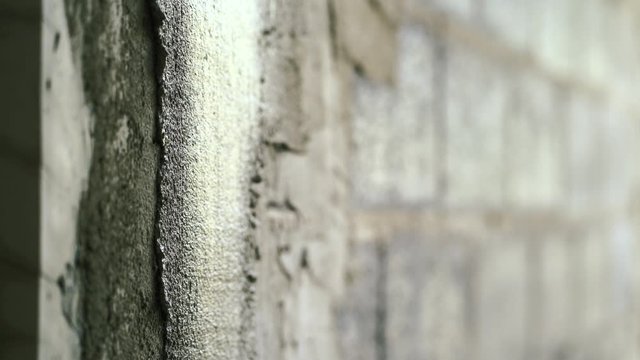 hand of worker plastering cement on wall