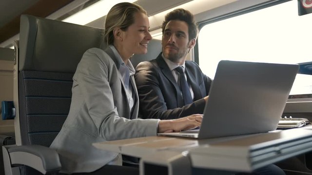 two colleagues working on a train