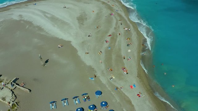 flying on a drone over a beautiful beach with turquoise water and shoreline with hotels of Rhodes Greece Europe. Ellie beach