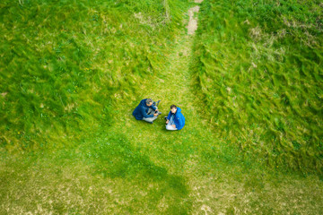 Aerial view of father and son flying drone