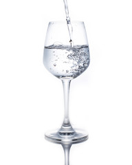 A glass of wine pouring water on a white background