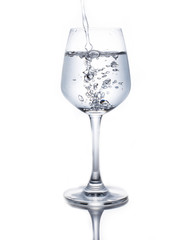 A glass of wine pouring water on a white background