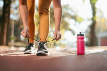 Young woman working out. Athlete woman getting ready for jogging.  Close up