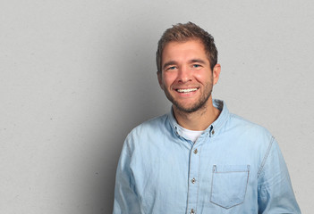 Young man in denim shirt is smiling