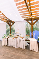 Wedding stand-up meal. Snack for guests. Celebration. Wedding buffet in restaurant outdoors, wooden tent. Catering
