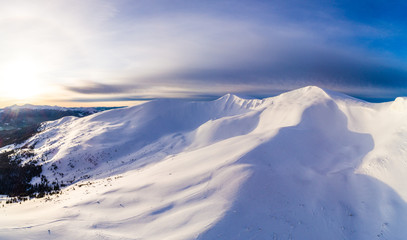 Aerial view of beautiful winter mountain slopes