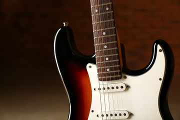 Obraz na płótnie Canvas Modern bass guitar against dark background, closeup