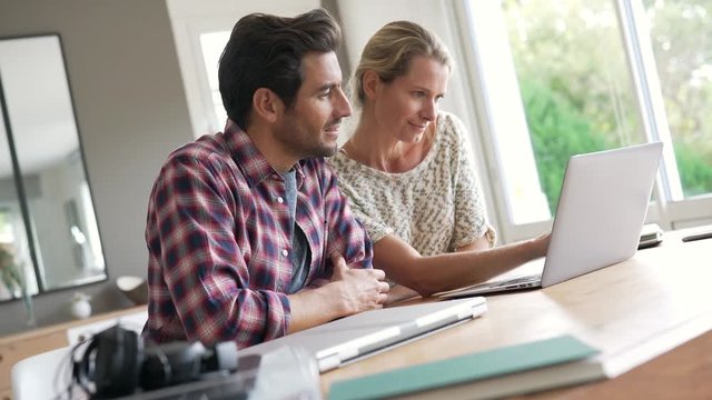 two young colleagues working in an office