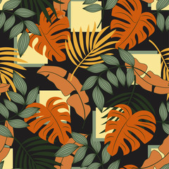 Abstract seamless tropical pattern with bright orange and green plants and leaves on dark background. Seamless pattern with colorful leaves and plants.   Vector design. Jungle print. Floral background