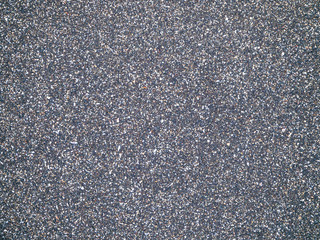 The texture of black volcanic sand. Bali