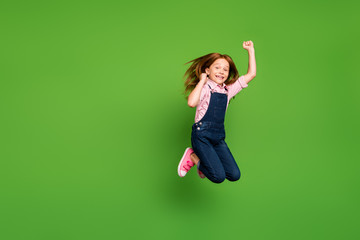 Full length photo of funny pretty little schoolchild jumping high rejoicing summer holidays...