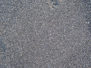 The texture of black volcanic sand. Bali