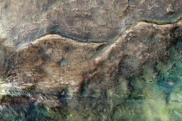 Old rusty bronze texture background in golden, green and metallic blue tones