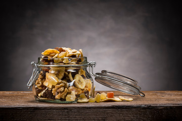 dehydrated fruit in open glass jar on wooden table