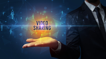 Elegant hand holding VIDEO SHARING inscription, social networking concept