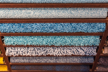 samples of multi-colored carpets on the shelves