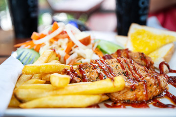 Grilled pork steak with salad on a plate