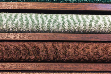 samples of multi-colored carpets on the shelves