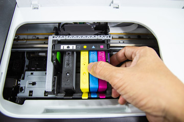 Technicians are install setup the ink cartridge of a inkjet printer the device of office automate...
