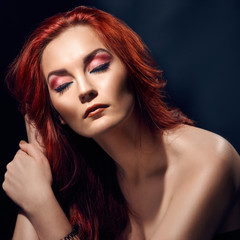 Fashionable portrait of beautiful redheaded model with naked shoulders