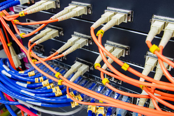 cable network , fiber optic cable connect to switch port in server room , Concept network management
