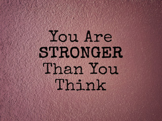 Motivational and inspirational wording - You Are Stronger Than You Think. Blurred styled background.