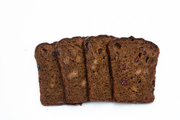Rye bread with raisins and nuts on a white background. Concept - bakery products, healthy food, vega, diet